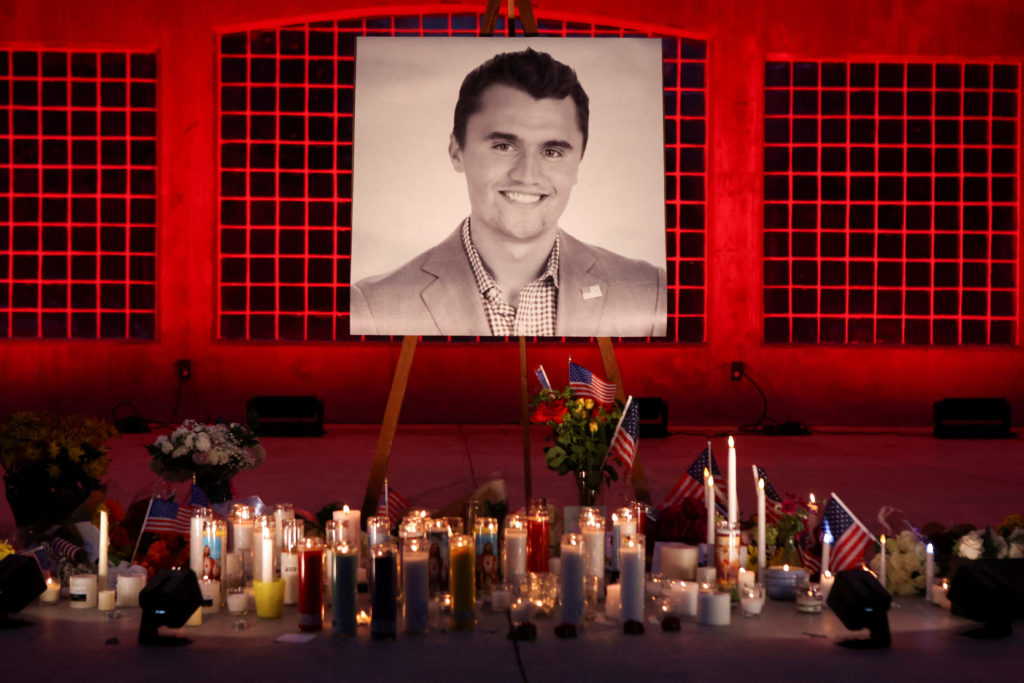 Flowers and candles at a vigil near an image of Charlie Kirk in Orem, Utah, after he was fatally shot; File Photo by Jim Urquhart/Reuters