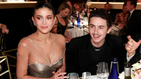 Kylie Jenner and Timothee Chalamet seated together inside the Golden Globes ceremony (Getty Images)