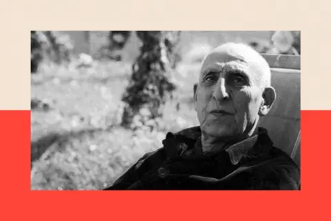 Deposed Iranian Prime Minister Mohammad Mossadeq seated outdoors, reflecting on the events of 1953