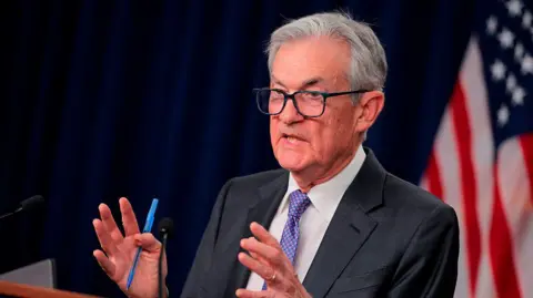 Jerome Powell seen speaking at a podium, motioning with his hands (Getty Images)