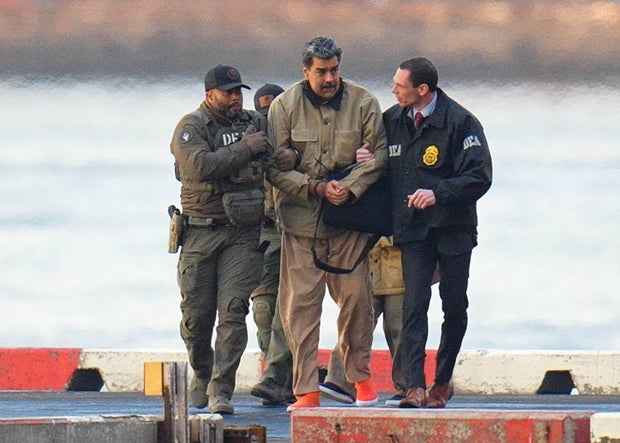 Nicolas Maduro in handcuffs after landing at a Manhattan helipad, escorted by federal agents, Jan. 5, 2026.