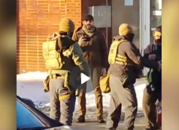 Screen grab showing Alex Pretti speaking with federal agents before he was fatally shot.