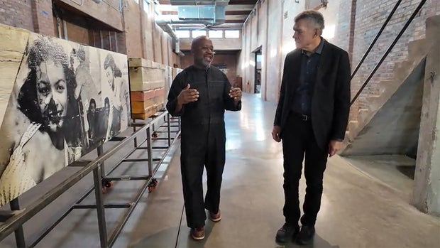 Artist Theaster Gates with correspondent Mark Whitaker (CBS News).