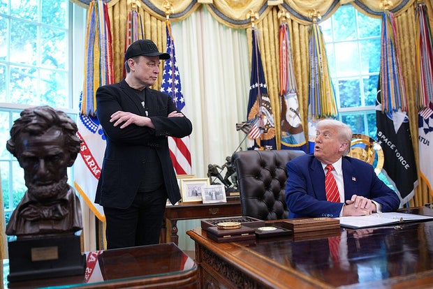 President Trump and Elon Musk speak to reporters in the Oval Office of the White House on May 30, 2025.
