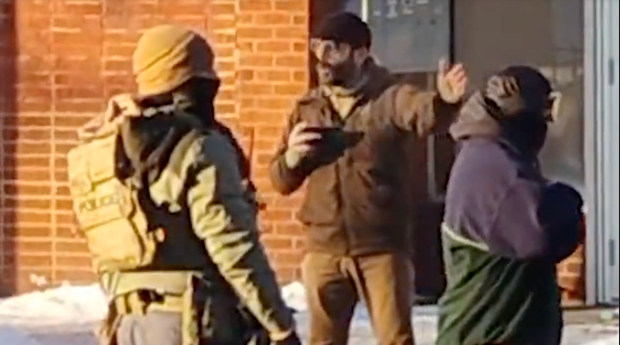 Alex Pretti holds a cellphone while speaking with federal agents minutes before he was fatally shot in Minneapolis. Video obtained by CBS News.