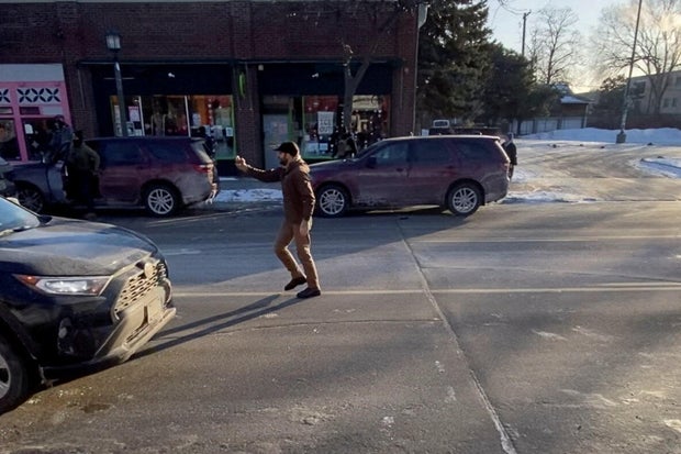 Alex Pretti records video in the street shortly before the shooting.