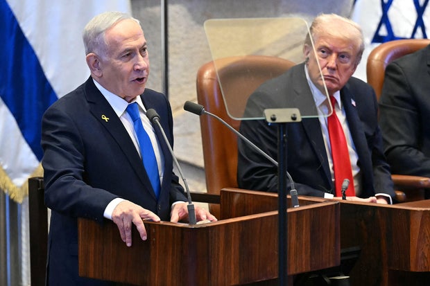 President Trump listens to Israeli Prime Minister Benjamin Netanyahu as he addresses the Knesset in Jerusalem on Oct. 13, 2025, after Israel and Hamas struck a ceasefire deal.