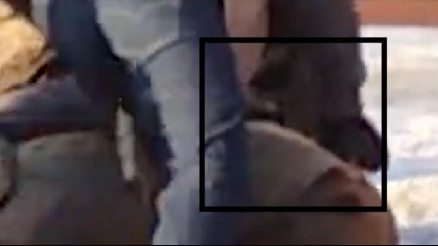 Closeup from video shows an officer removing a gun from Alex Pretti's waistband moments before shots were fired.