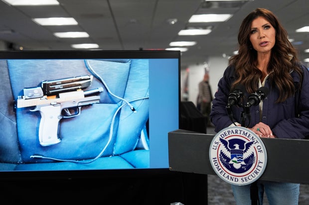 Homeland Security Secretary Kristi Noem displays a photo of the firearm she says was carried by the man killed in Minneapolis.