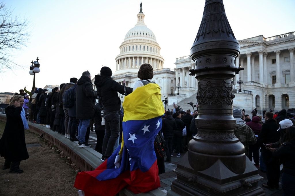A person draped in a Venezuelan flag faces the U.S. Capitol in Washington, D.C., Jan. 15, 2026. Photo by Annabelle Gordon/Reuters.