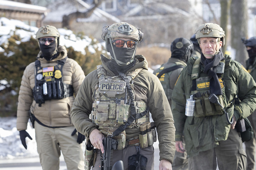 Federal law-enforcement officers in tactical gear, representing ICE/HSI agents.