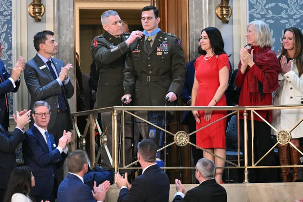Guests watch as a medal is presented in the House gallery during President Trump's 2026 State of the Union.