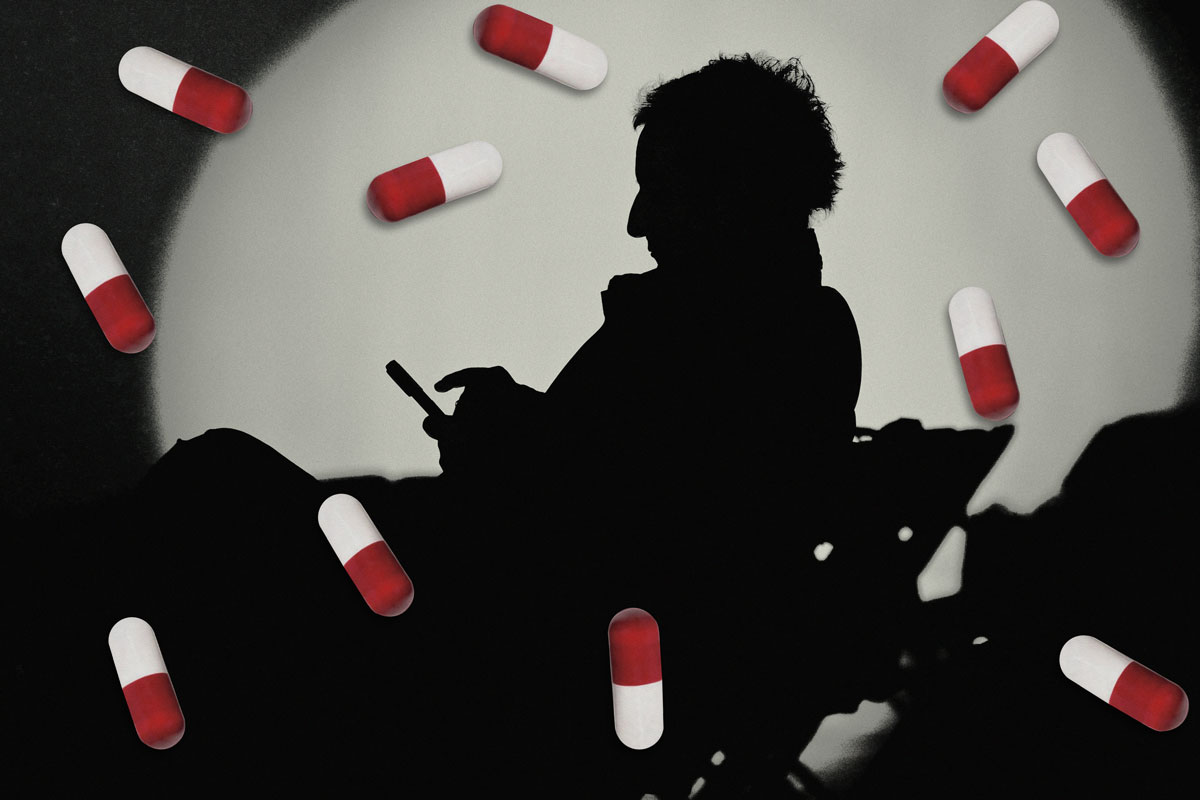 Concept image: a silhouetted person beside scattered pills, illustrating SSRI use for anxiety.