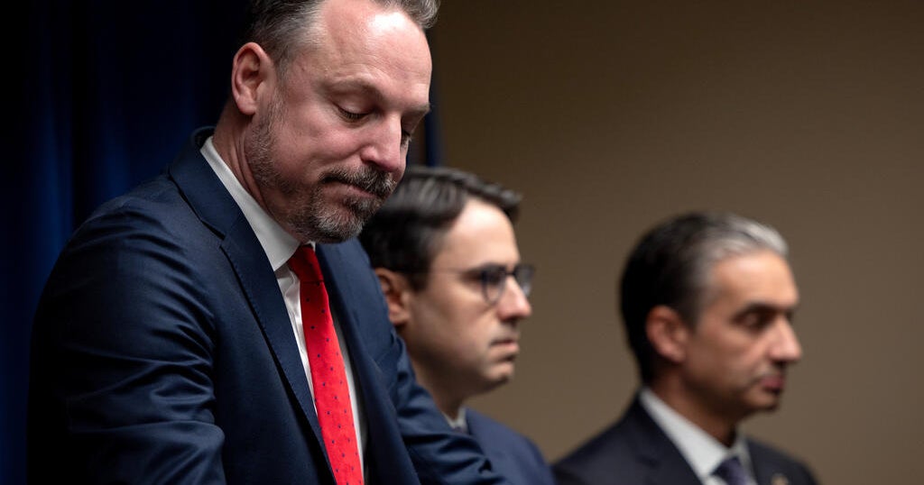 Justice Department officials at a press briefing, underscoring DOJ's swift move to remove Donald T. Kinsella after his appointment.