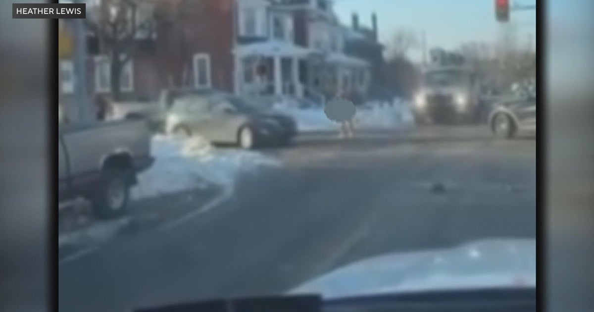 Dashcam-like view of a roadway at night with vehicles ahead, suggesting a fast-moving scene
