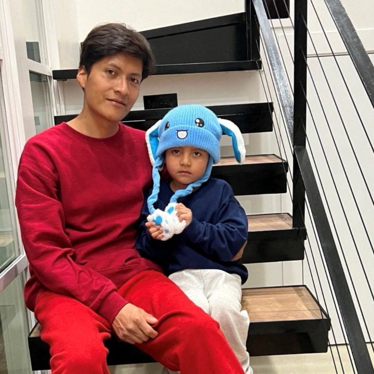 Left: Liam Conejo Ramos and his father Adrian Alexander Conejo Arias, who were detained with his father by immigration officers during a raid in Minnesota and then taken to a detention center in Texas, sit on the stairs back at their home after a judge ordered their release, in Columbia Heights, Minnesota, U.S., in this picture obtained from social media February 1, 2026. File photo by Joaquin Castro via BlueSky/via Reuters - pbs