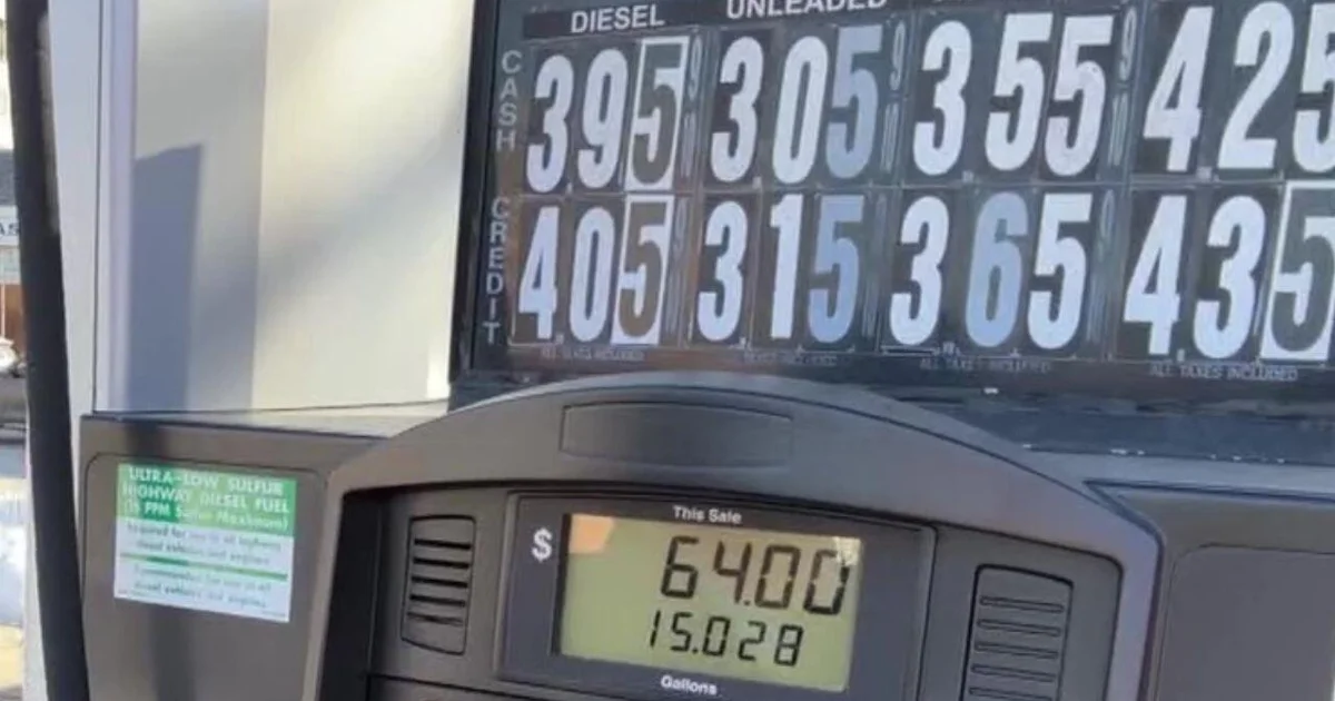 Gas station price board and pump, reflecting higher fuel prices alongside rising crude