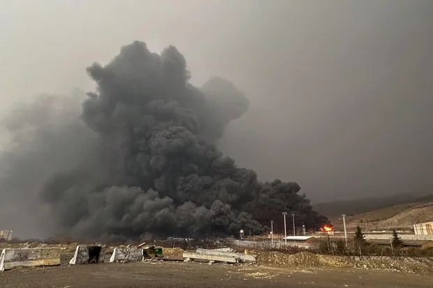 Smoke and flames at an oil depot in Tehran after reported strikes, March 8, 2026.
