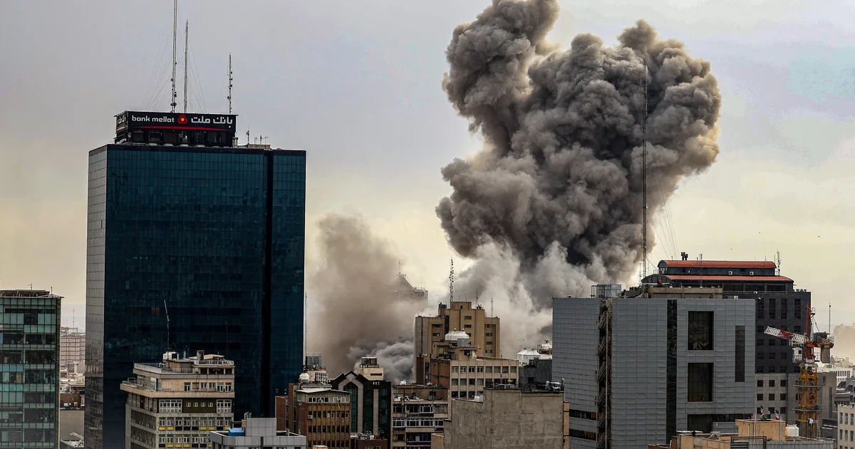 Smoke rises over a city skyline amid regional unrest, underscoring Iran-related security concerns raised in Congress