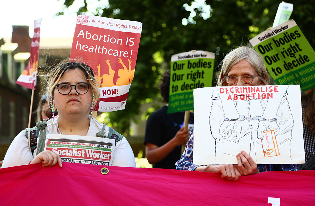Protesters holding abortion rights signs at a rally
