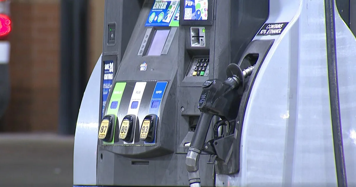 Close-up of a gas pump nozzle and controls, reflecting war-driven energy price pressures feeding inflation.
