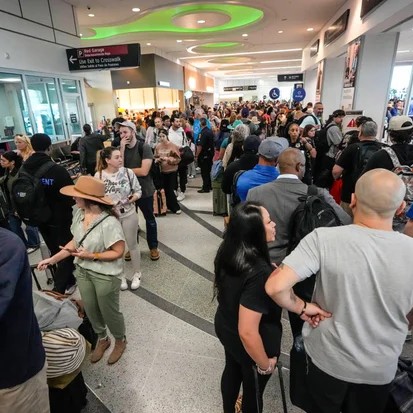 Airline passengers wait in long lines to get through the TSA security screening at William P. Hobby Airport in Houston, Sunday, March 8, 2026. - Brett Coomer/Houston Chronicle via AP