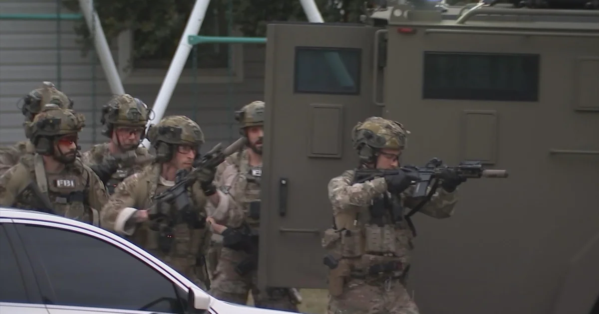 FBI agents during an operation, illustrating the federal investigation into the Gracie Mansion IED case.