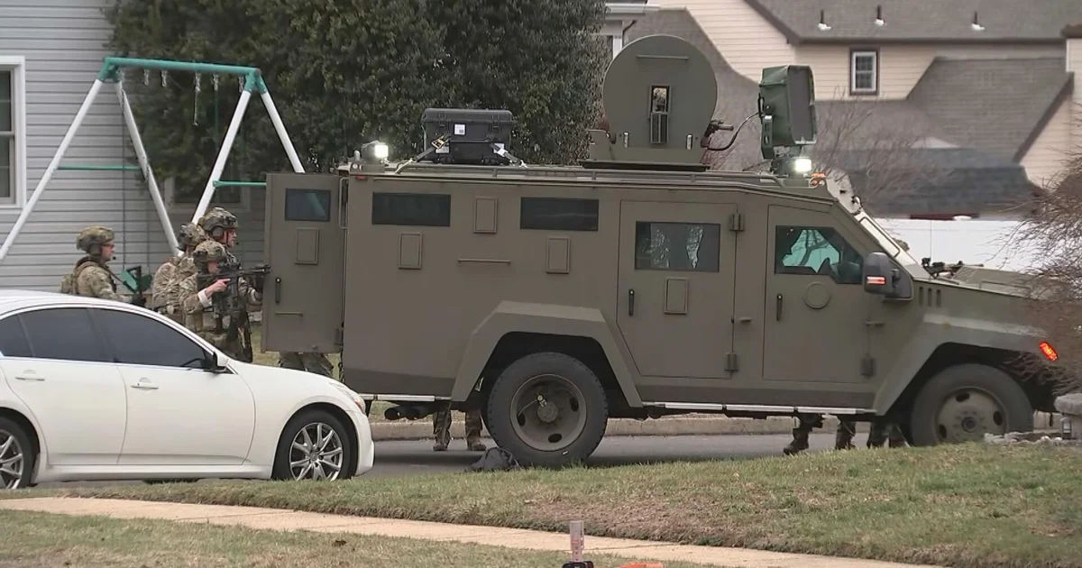 Armored police vehicle and tactical officers illustrating a heightened law-enforcement response.