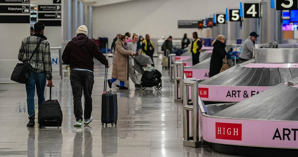 Crowded airport baggage area illustrating congestion during the shutdown