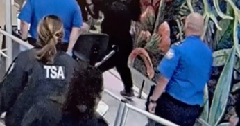 TSA officers screening passengers at a checkpoint during longer wait times