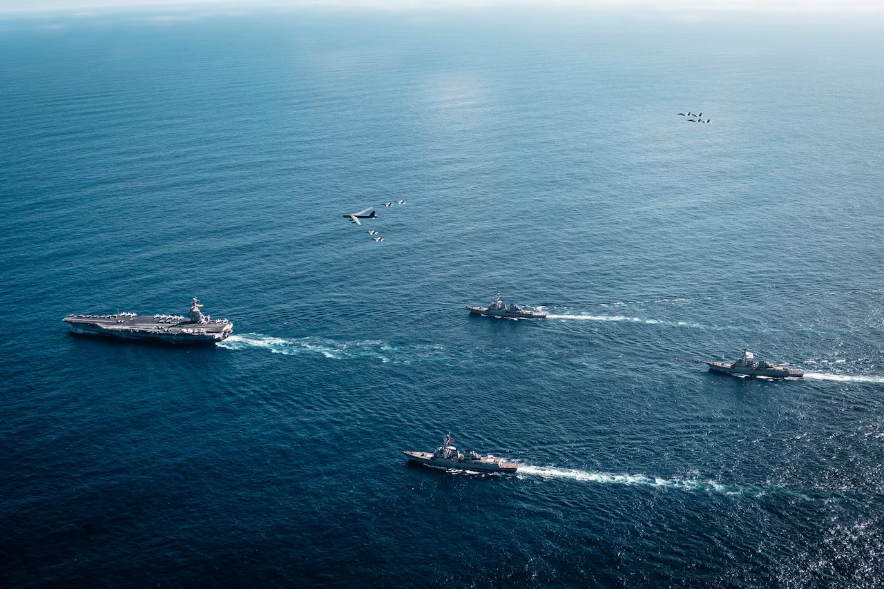 U.S. Navy ships and aircraft at sea, illustrating maritime interdiction operations.