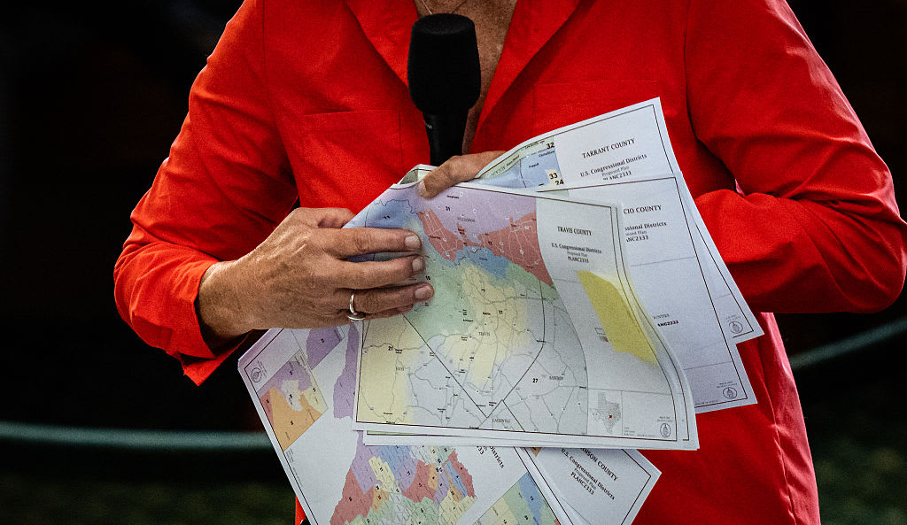 Election district maps and campaign materials on a table, illustrating the Texas runoff.
