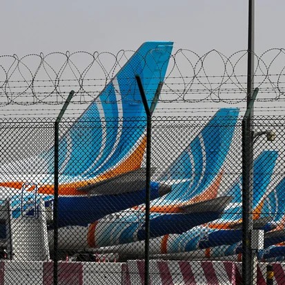 FlyDubai airline planes are parked on the tarmac at Dubai International Airport in Dubai on March 2, 2026. - Fadel SENNA /AFP via Getty Images