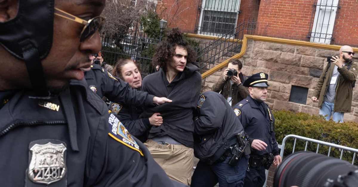 Police detain a protester outside Gracie Mansion during demonstrations.