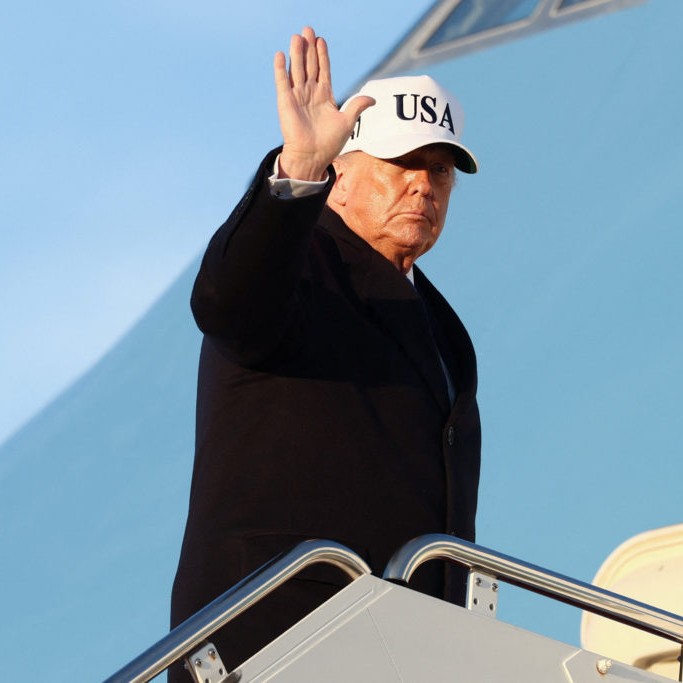 Left: President Donald Trump waves as he boards Air Force One for travel to Florida, at Joint Base Andrews, Maryland, March 13, 2026. Photo by Kevin Lamarque/ Reuters - Kevin Lamarque / Reuters