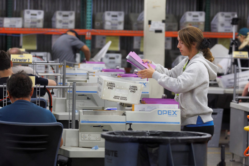 Election workers sort mail-in ballots at the Orange County Registrar of Voters in Santa Ana, California