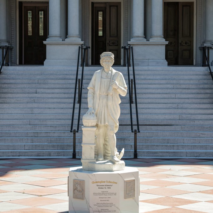 Left: A statue of Italian explorer Christopher Columbus stands outside the Eisenhower Executive Office Building near the White House in Washington, D.C., March 23, 2026. Photo by Kylie Cooper/Reuters - Kylie Cooper/Reuters
